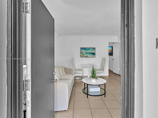 tiled living room featuring a textured ceiling