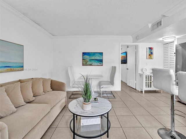 tiled living room featuring a textured ceiling and ornamental molding