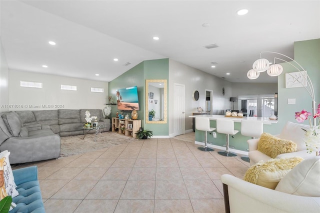 living room featuring light tile patterned floors and vaulted ceiling