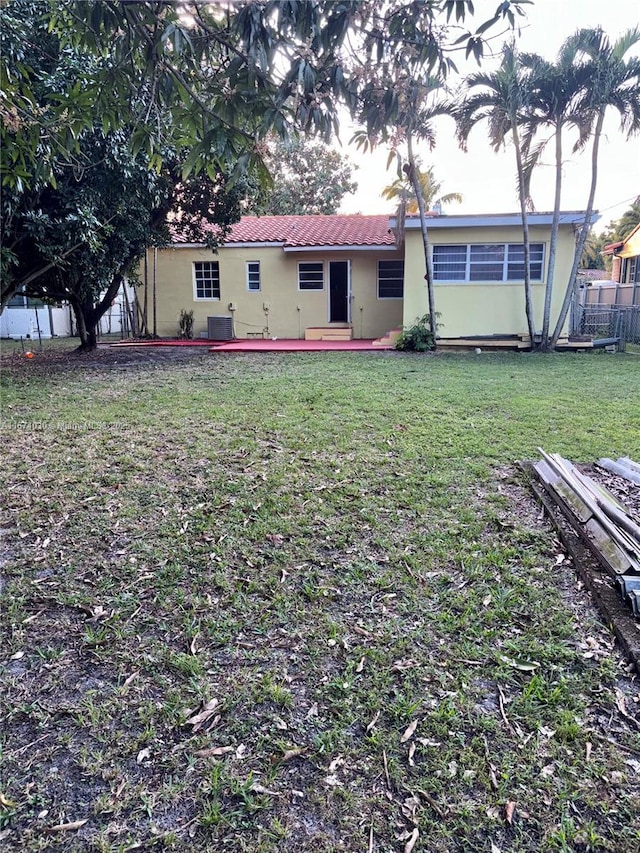 back of house with a lawn