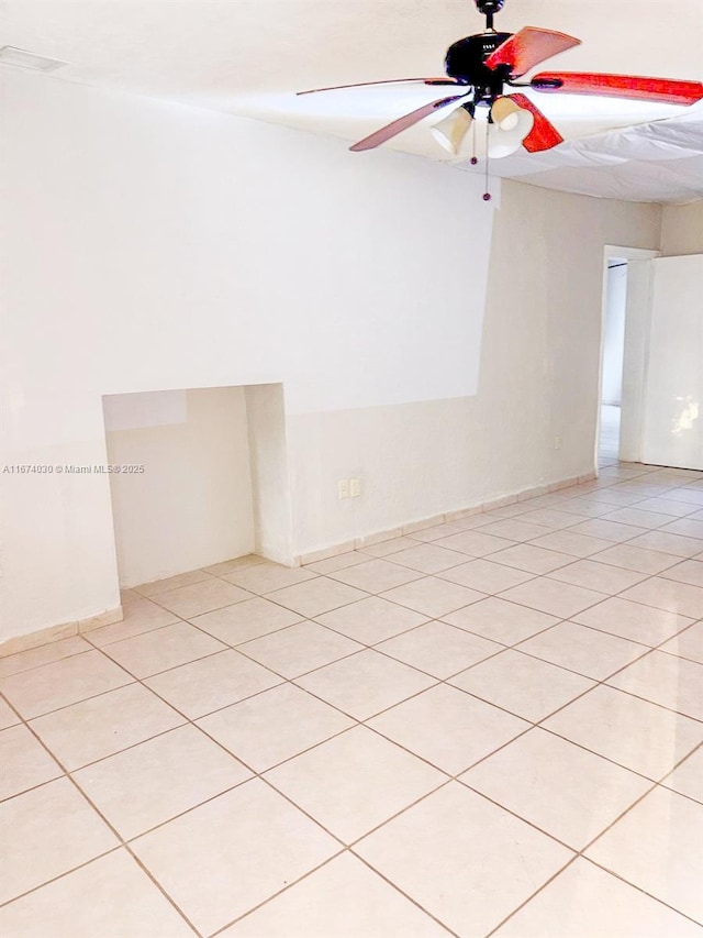 unfurnished room with ceiling fan and light tile patterned flooring