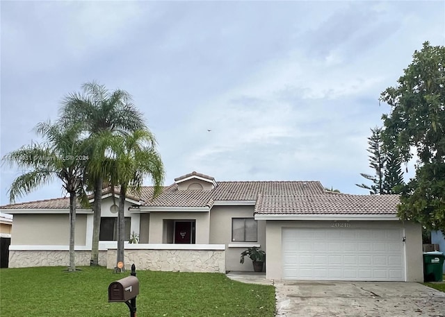 view of front facade with a garage and a front lawn