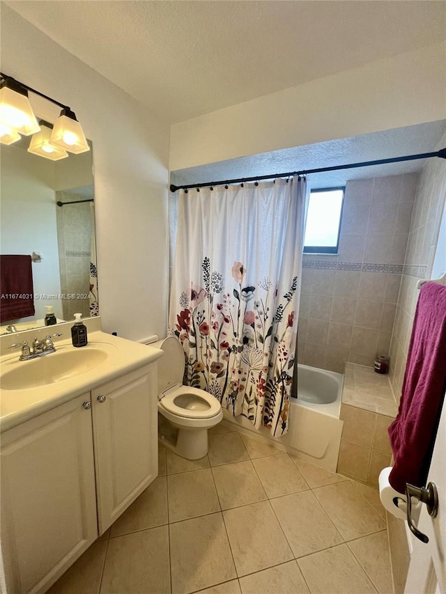 full bathroom with shower / tub combo with curtain, tile patterned flooring, vanity, and toilet