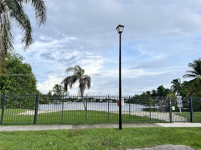 exterior space with a water view and a lawn