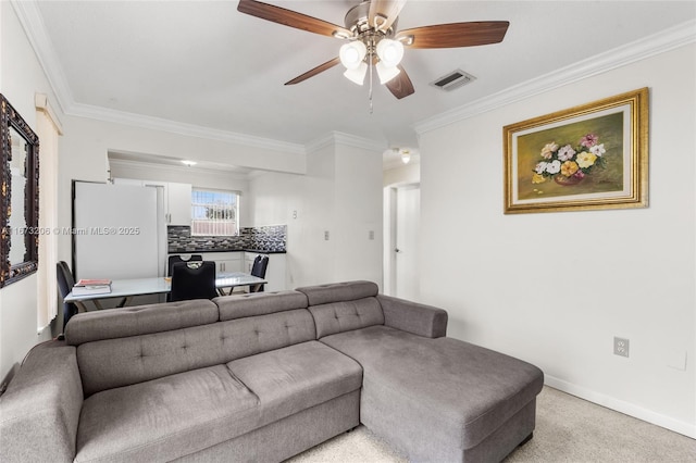 living room with ceiling fan, light colored carpet, and crown molding