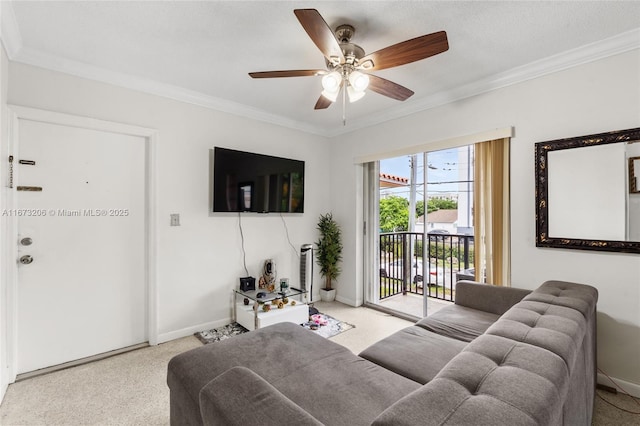 living room with ceiling fan and crown molding