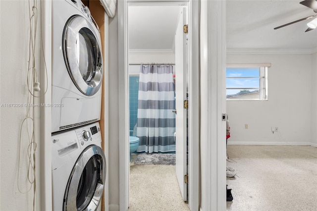 clothes washing area with crown molding, ceiling fan, and stacked washer and clothes dryer