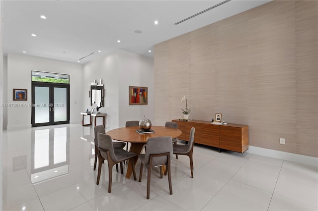 tiled dining space featuring french doors