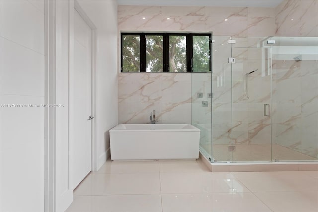 bathroom featuring tile patterned floors, independent shower and bath, and tile walls