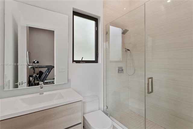 bathroom with vanity, an enclosed shower, and toilet