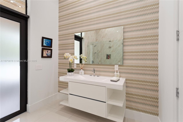 bathroom with walk in shower, vanity, and tile patterned flooring