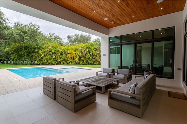 view of pool with outdoor lounge area and a patio