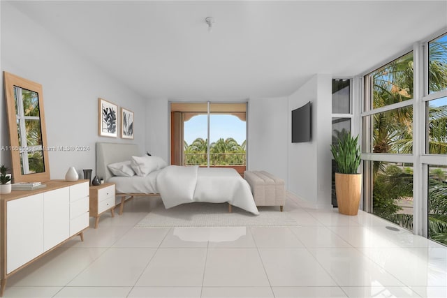 bedroom featuring floor to ceiling windows and light tile patterned floors