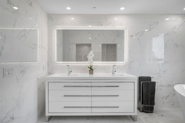 bathroom with tile walls, vanity, and a tub to relax in