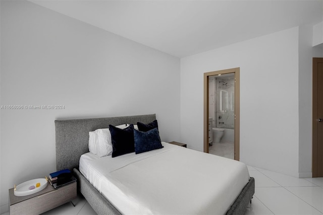 bedroom with connected bathroom and light tile patterned floors