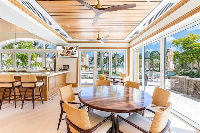 dining area featuring wooden ceiling, light wood-type flooring, a healthy amount of sunlight, and ceiling fan