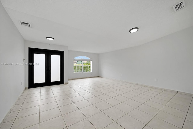 tiled entrance foyer featuring french doors