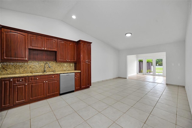 kitchen featuring light stone countertops, sink, light tile patterned flooring, dishwasher, and vaulted ceiling