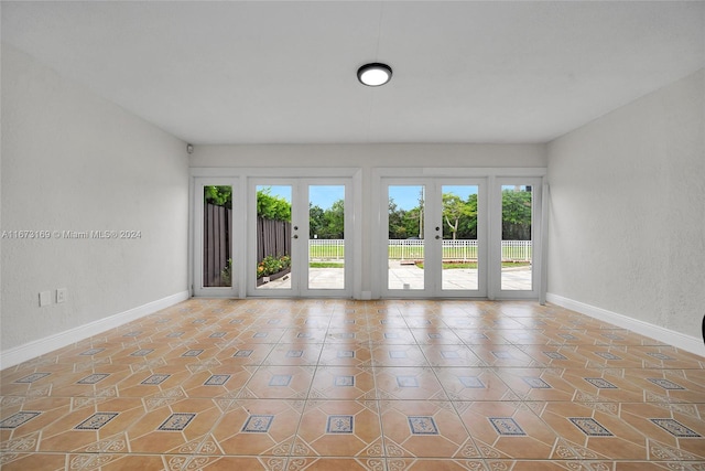 tiled spare room with french doors