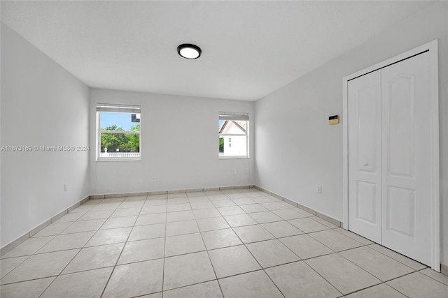 unfurnished room with a wealth of natural light and light tile patterned floors