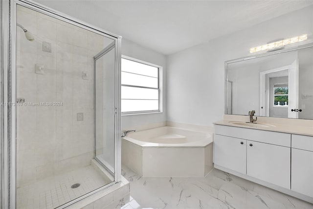 bathroom with vanity and independent shower and bath