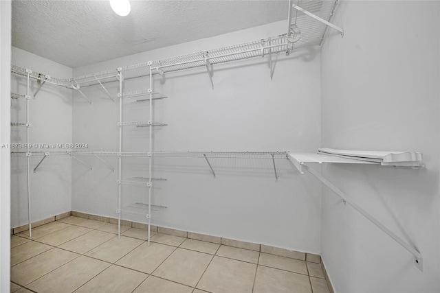 spacious closet featuring tile patterned floors