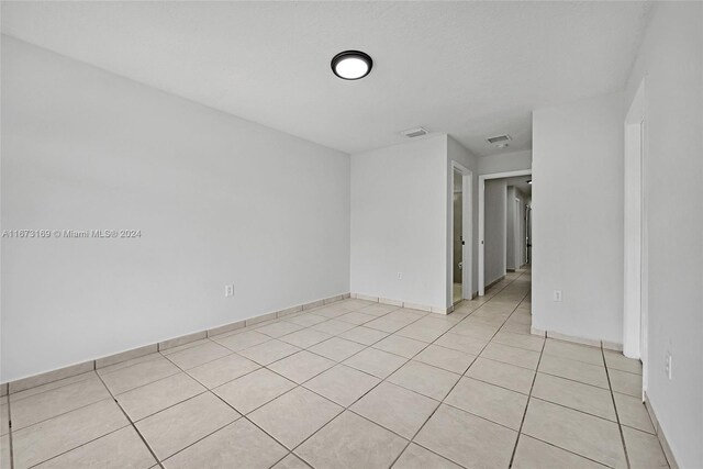 empty room with light tile patterned floors