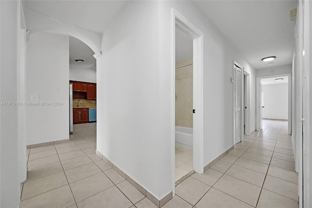 hall with light tile patterned flooring