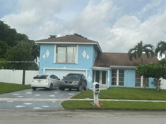 view of front facade featuring a garage and a front lawn