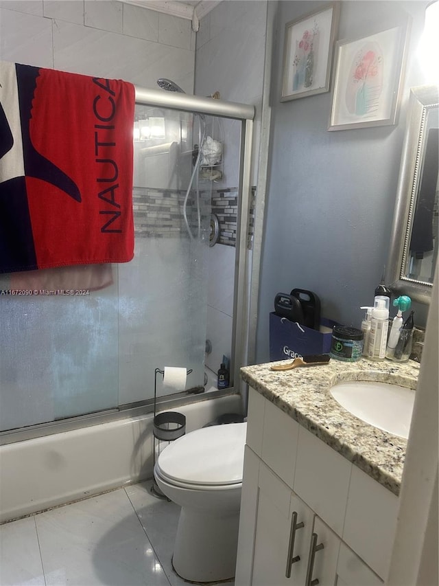 full bathroom featuring shower / bath combination with glass door, vanity, and toilet