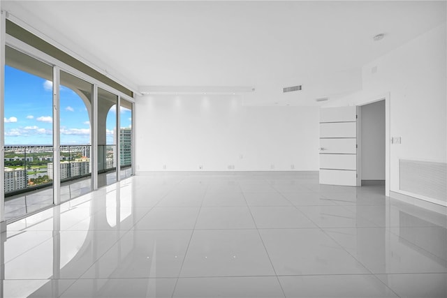 tiled spare room with expansive windows