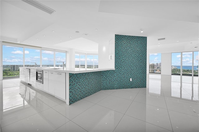 kitchen with light tile patterned flooring and white cabinetry