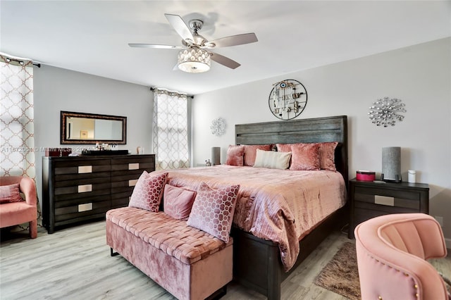 bedroom with ceiling fan and light hardwood / wood-style floors