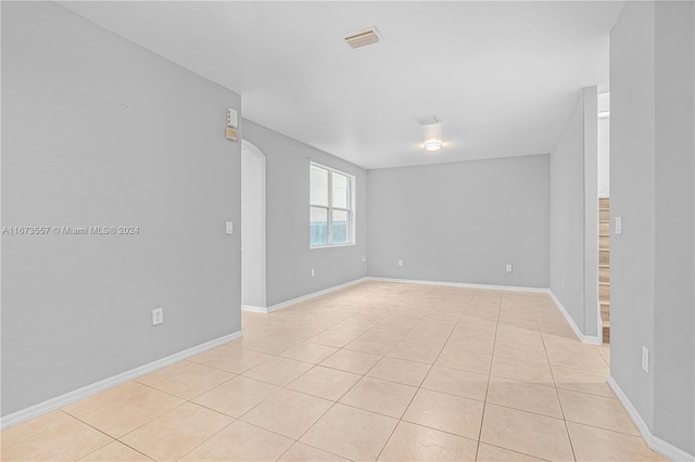 unfurnished room with light tile patterned flooring