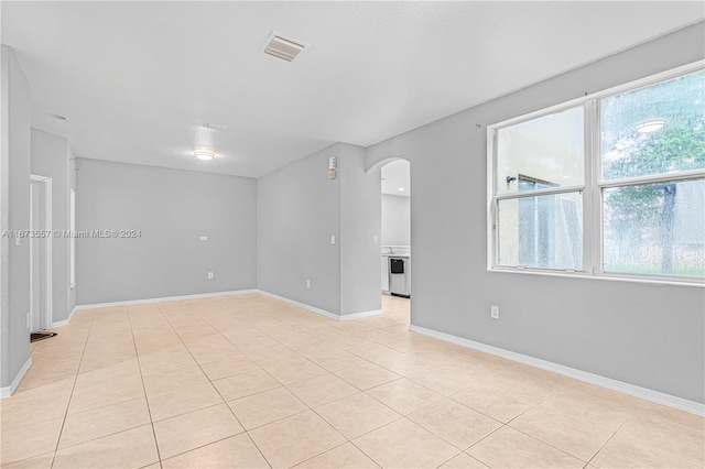 spare room featuring light tile patterned floors