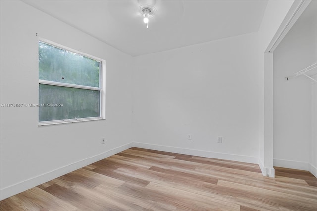 spare room with ceiling fan and light hardwood / wood-style floors