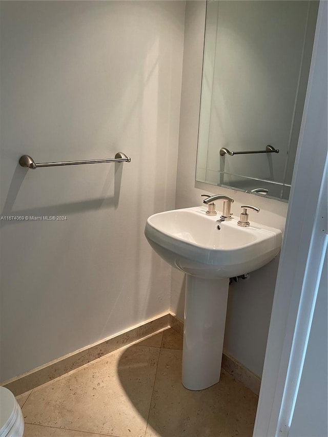 bathroom with tile patterned flooring and toilet