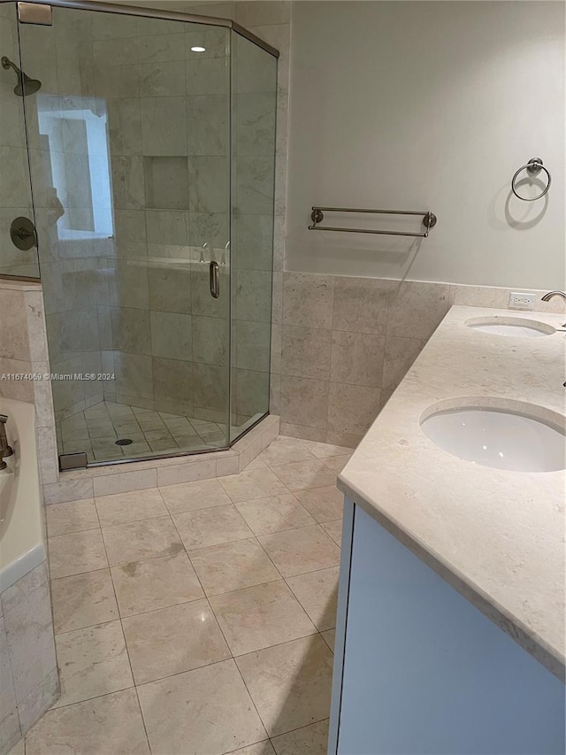 bathroom with plus walk in shower, tile patterned floors, and vanity