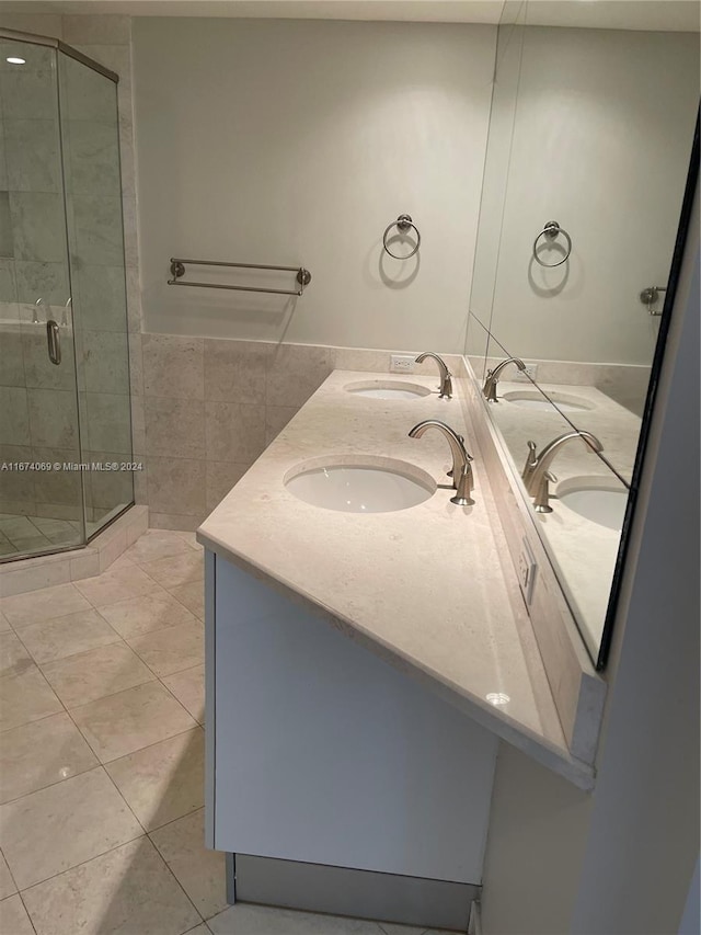 bathroom featuring an enclosed shower, tile patterned floors, and vanity