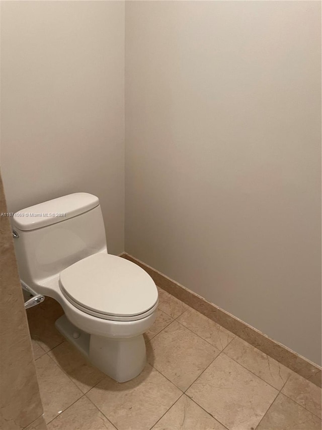 bathroom featuring toilet and tile patterned floors