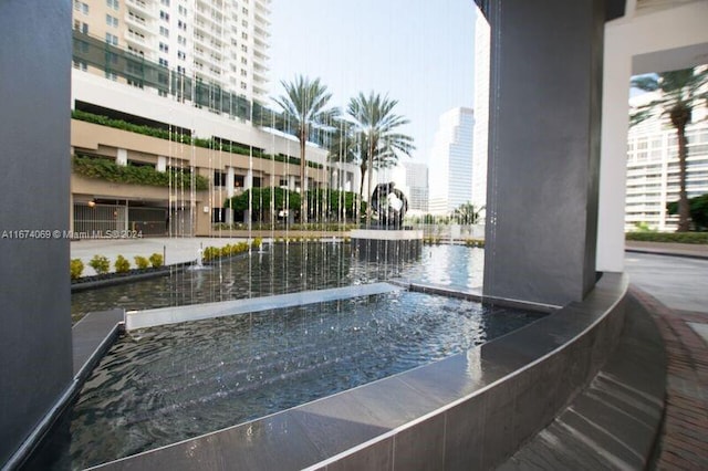 view of swimming pool featuring a water view