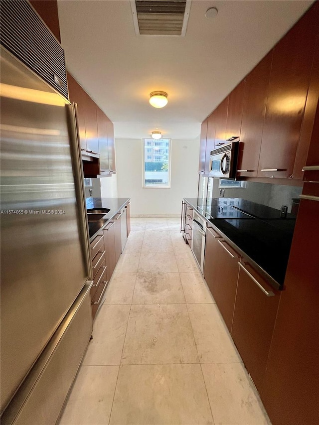 kitchen with stainless steel appliances and light tile patterned floors