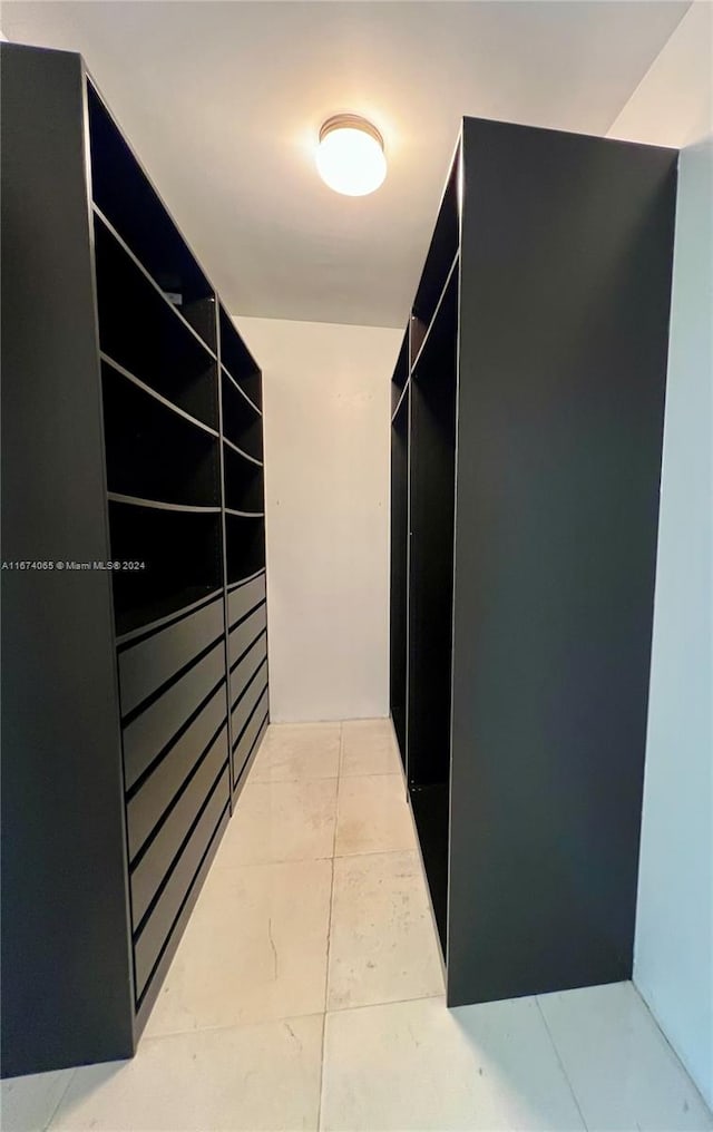 spacious closet with light tile patterned floors