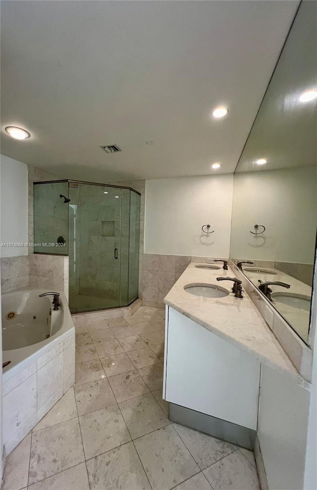 bathroom featuring tile patterned flooring, separate shower and tub, and vanity