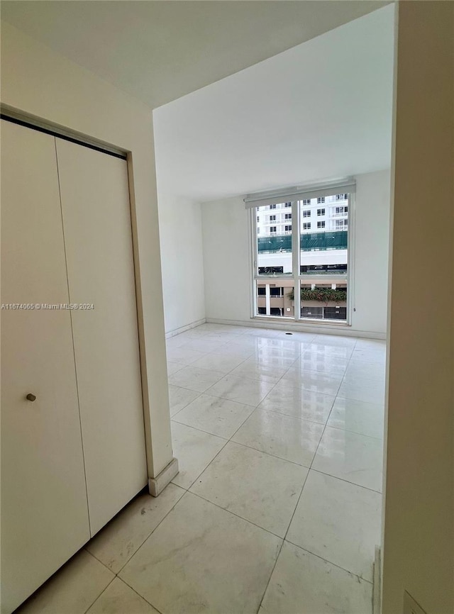 hall featuring light tile patterned floors