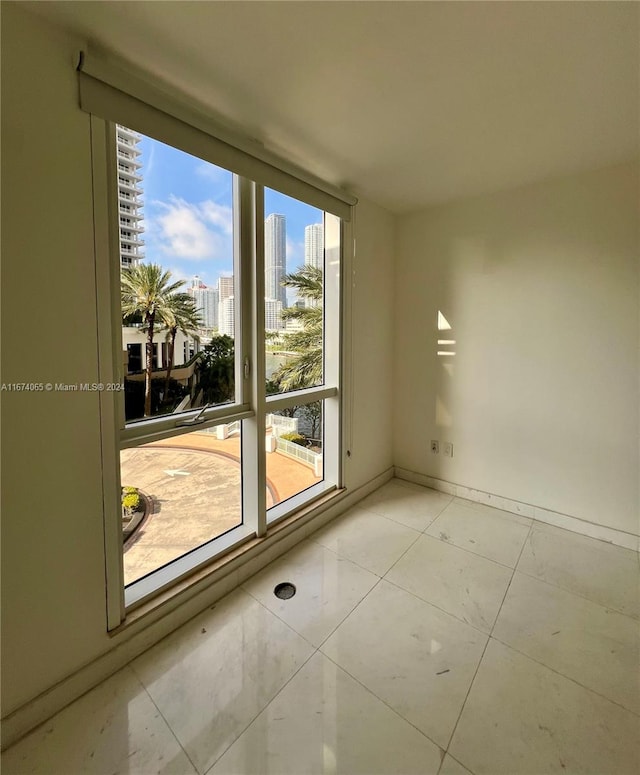 empty room with light tile patterned flooring