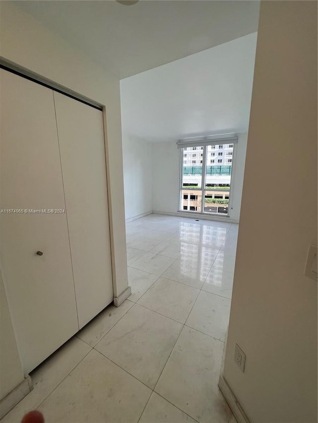 hallway with light tile patterned flooring