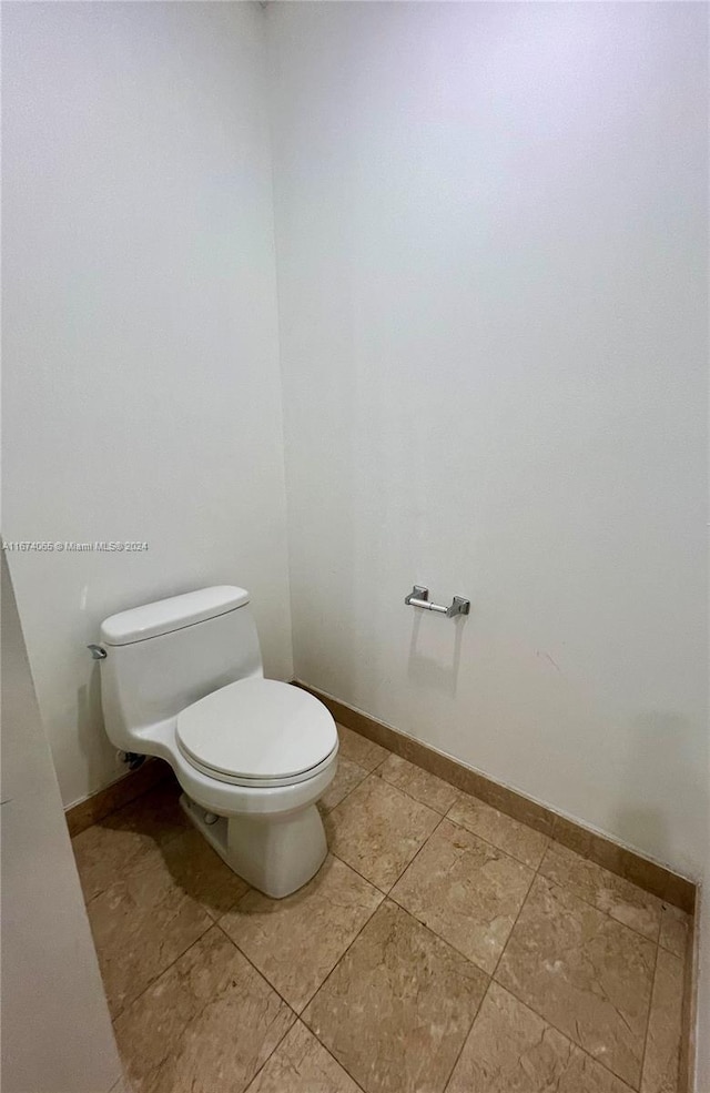 bathroom featuring tile patterned flooring and toilet