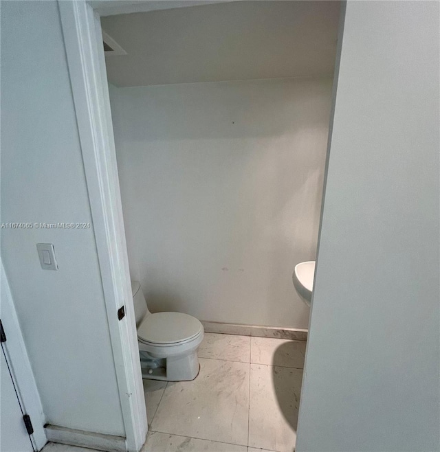 bathroom featuring tile patterned floors and toilet