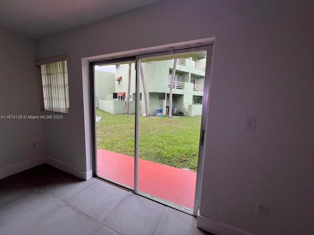 doorway to outside featuring light tile patterned flooring